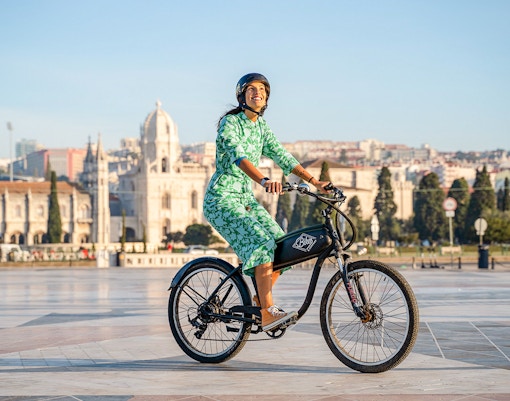 Person riding e-bike near Jerónimos Monastery, Lisbon, on Belém Riverside tour.