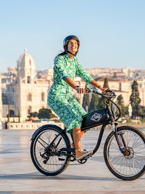 Person riding e-bike near Jerónimos Monastery, Lisbon, on Belém Riverside tour.