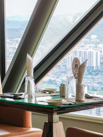 Dining table with city view at ARAS Revolving Restaurant, Kuala Lumpur.