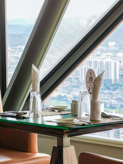 Dining table with city view at ARAS Revolving Restaurant, Kuala Lumpur.