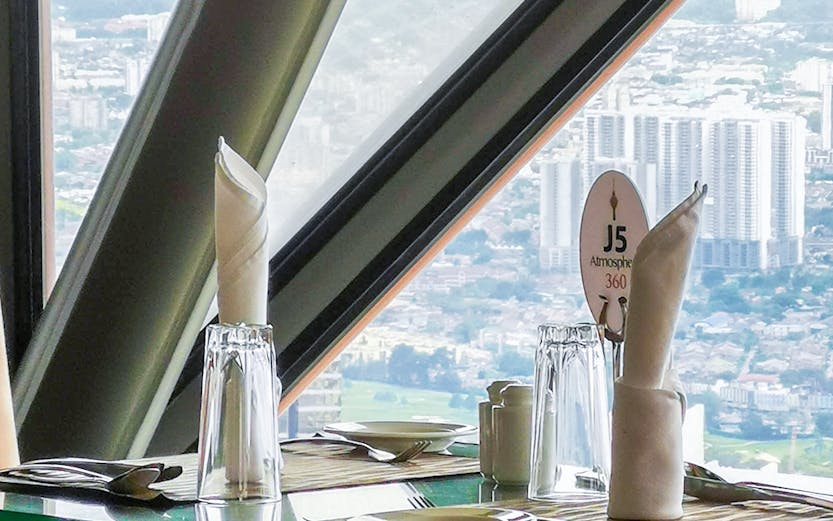Dining table with city view at ARAS Revolving Restaurant, Kuala Lumpur.