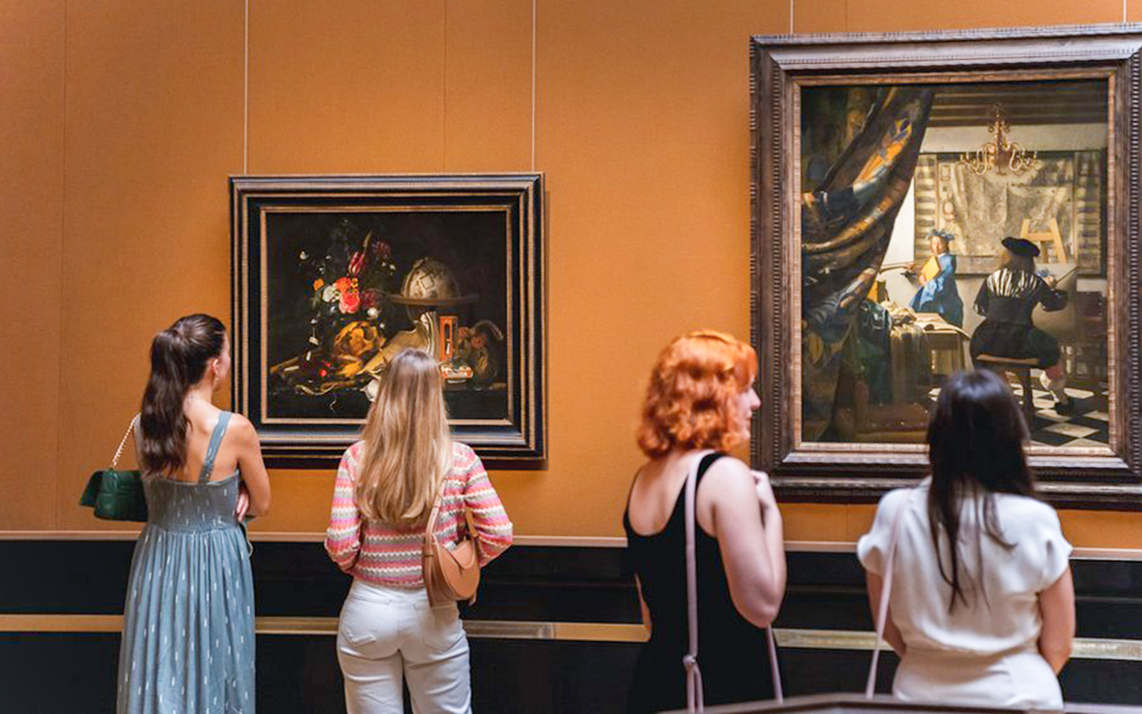 Visitors observing paintings at Kunsthistorisches Museum Vienna.