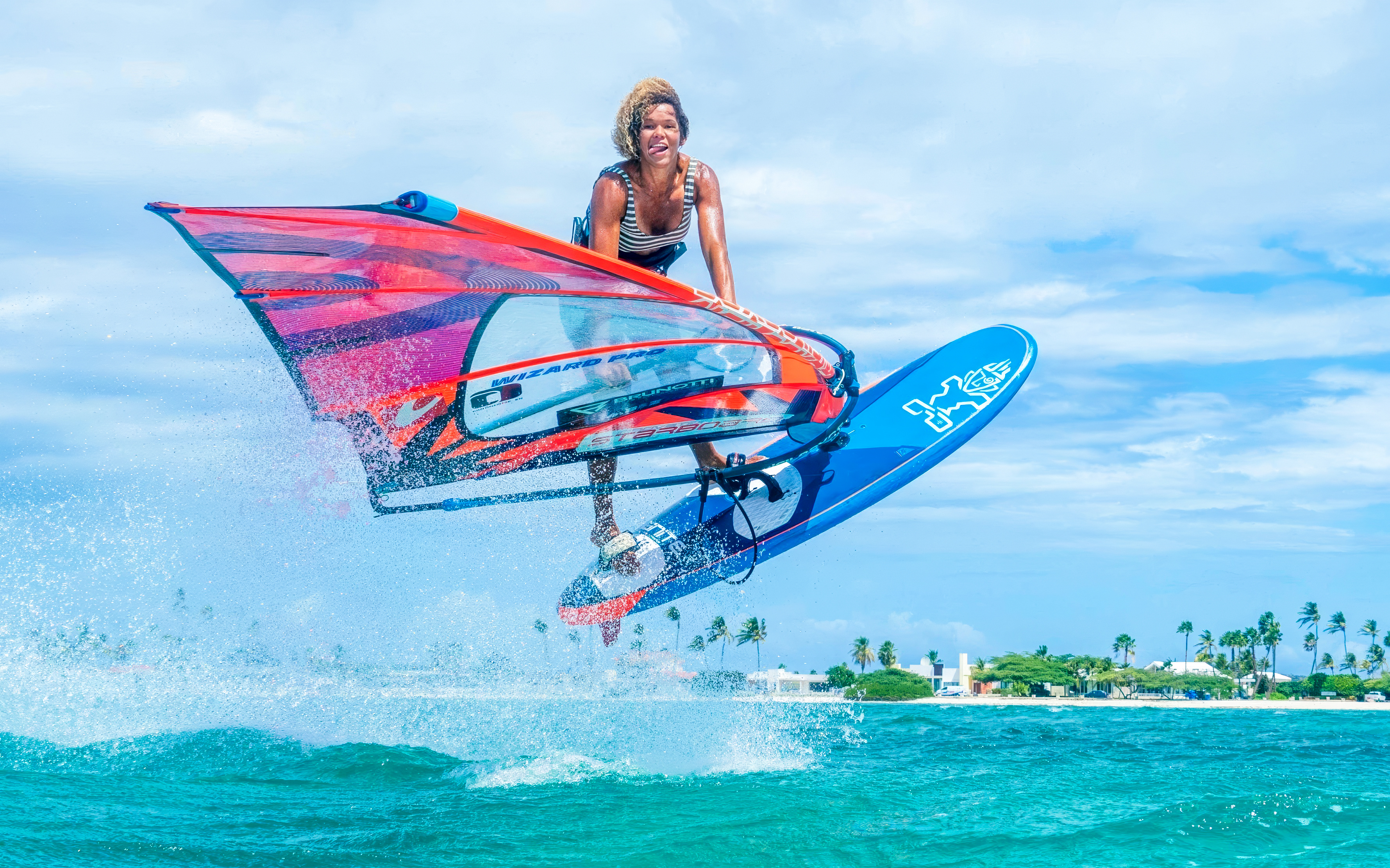 Windsurfer catching air over waves in Delta Neretva, Croatia.