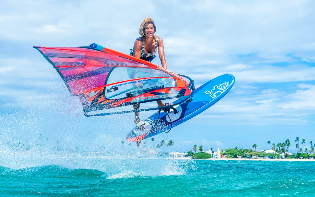 Windsurfer catching air over waves in Delta Neretva, Croatia.