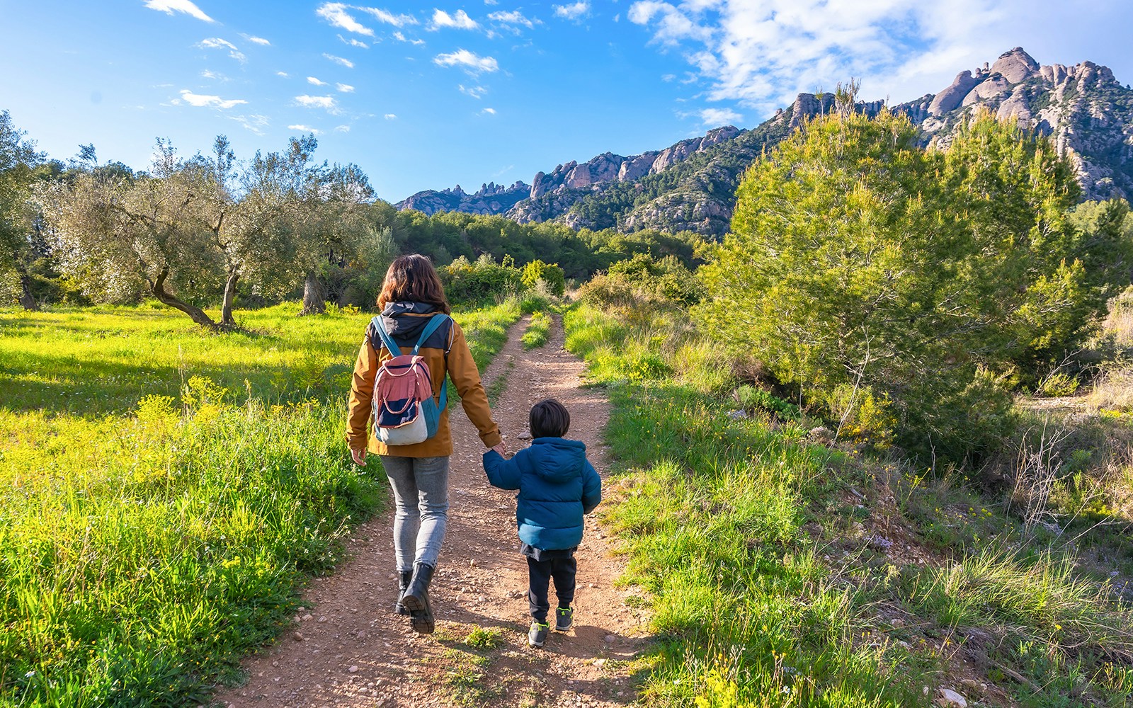 Mother and son hiking in montserrat mountains on sunny day