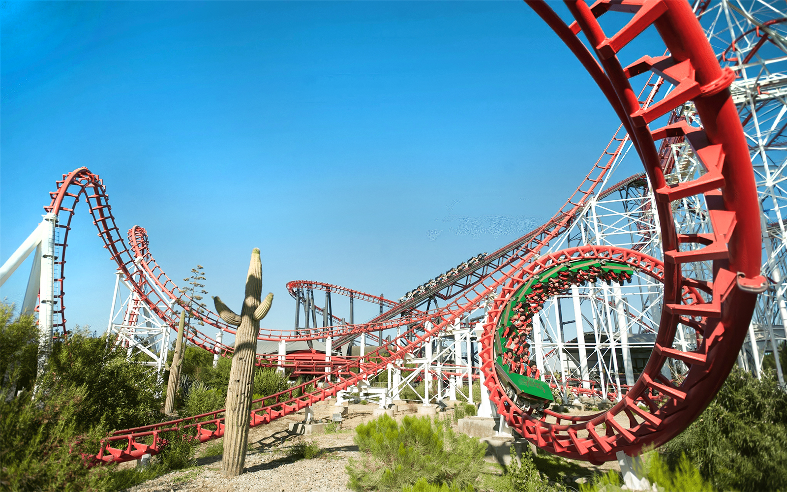 Viper Rollercoaster at Six Flags Magic Mountain with red loops and desert landscape.