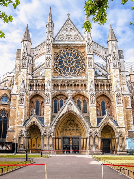 Westminster Abbey exterior with Gothic architecture and rose window in London.