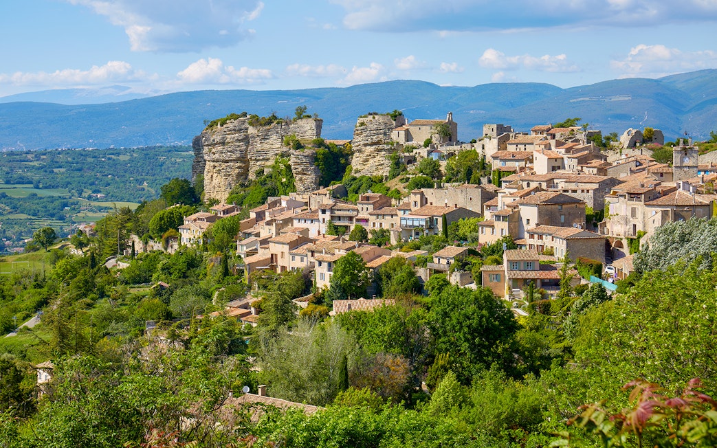Hilltop village in Provence with stone houses and lush greenery, part of Lavender Full Day Tour.