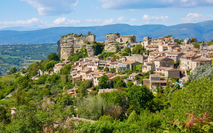 Hilltop village in Provence with stone houses and lush greenery, part of Lavender Full Day Tour.