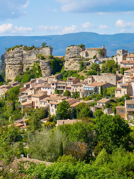 Hilltop village in Provence with stone houses and lush greenery, part of Lavender Full Day Tour.