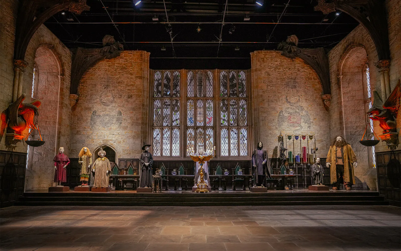 Costumes displayed in the Great Hall set from Harry Potter films.