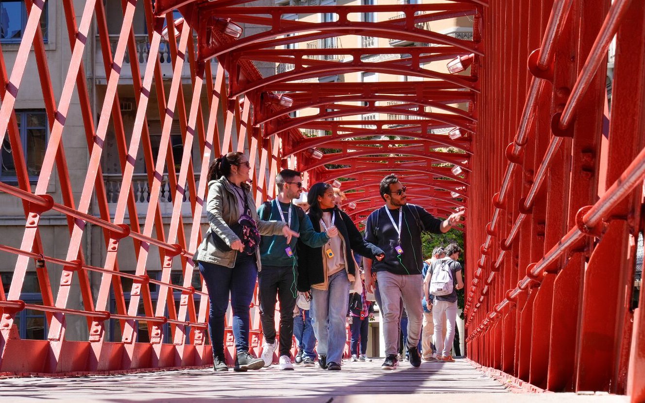 Tourists with guide on Pont de les Peixateries Velles, Girona, Spain.
