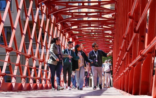 Tourists with guide on Pont de les Peixateries Velles, Girona, Spain.