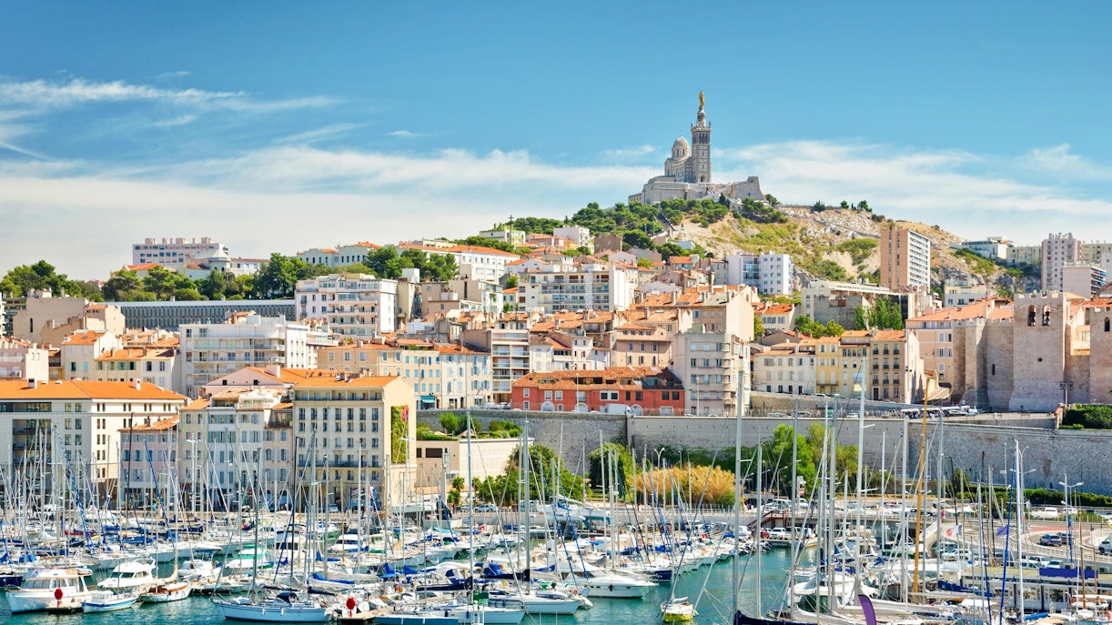 Vieux-Port of Marseille with boats and Notre-Dame de la Garde on the hill.