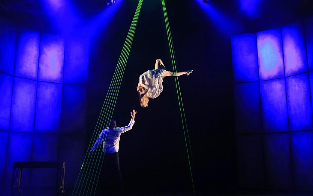Performer suspended in mid-air during Jamie Allan's Amaze theatre act.