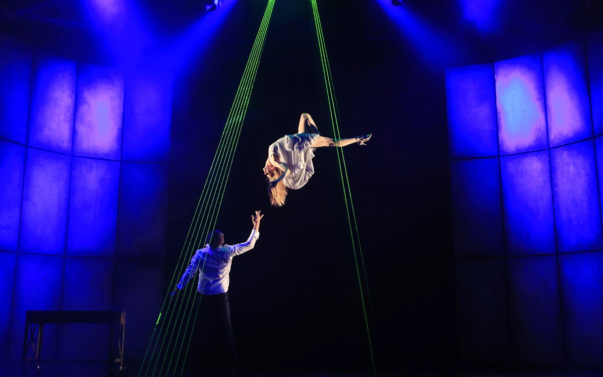 Performer suspended in mid-air during Jamie Allan's Amaze theatre act.
