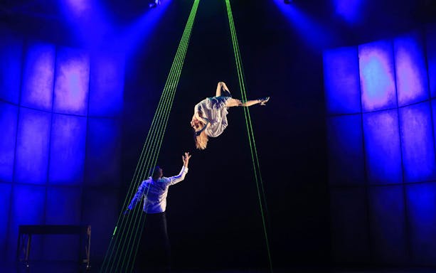 Performer suspended in mid-air during Jamie Allan's Amaze theatre act.