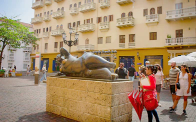 Tour group viewing Botero sculpture in Cartagena's historic walled city.