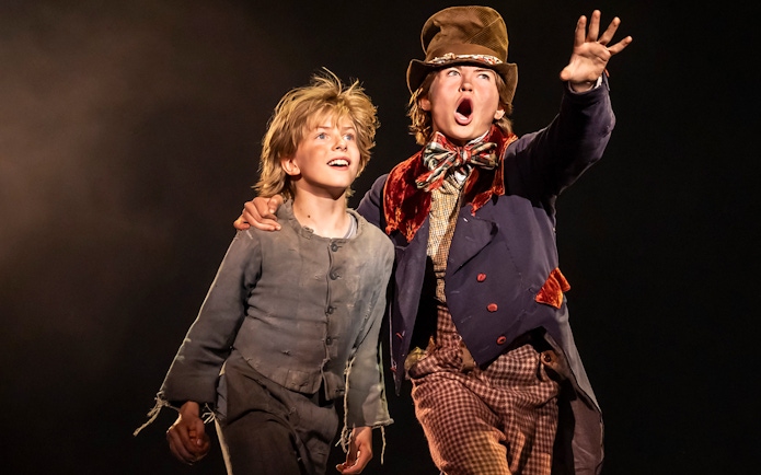 Two actors on stage performing a scene from the musical Oliver!