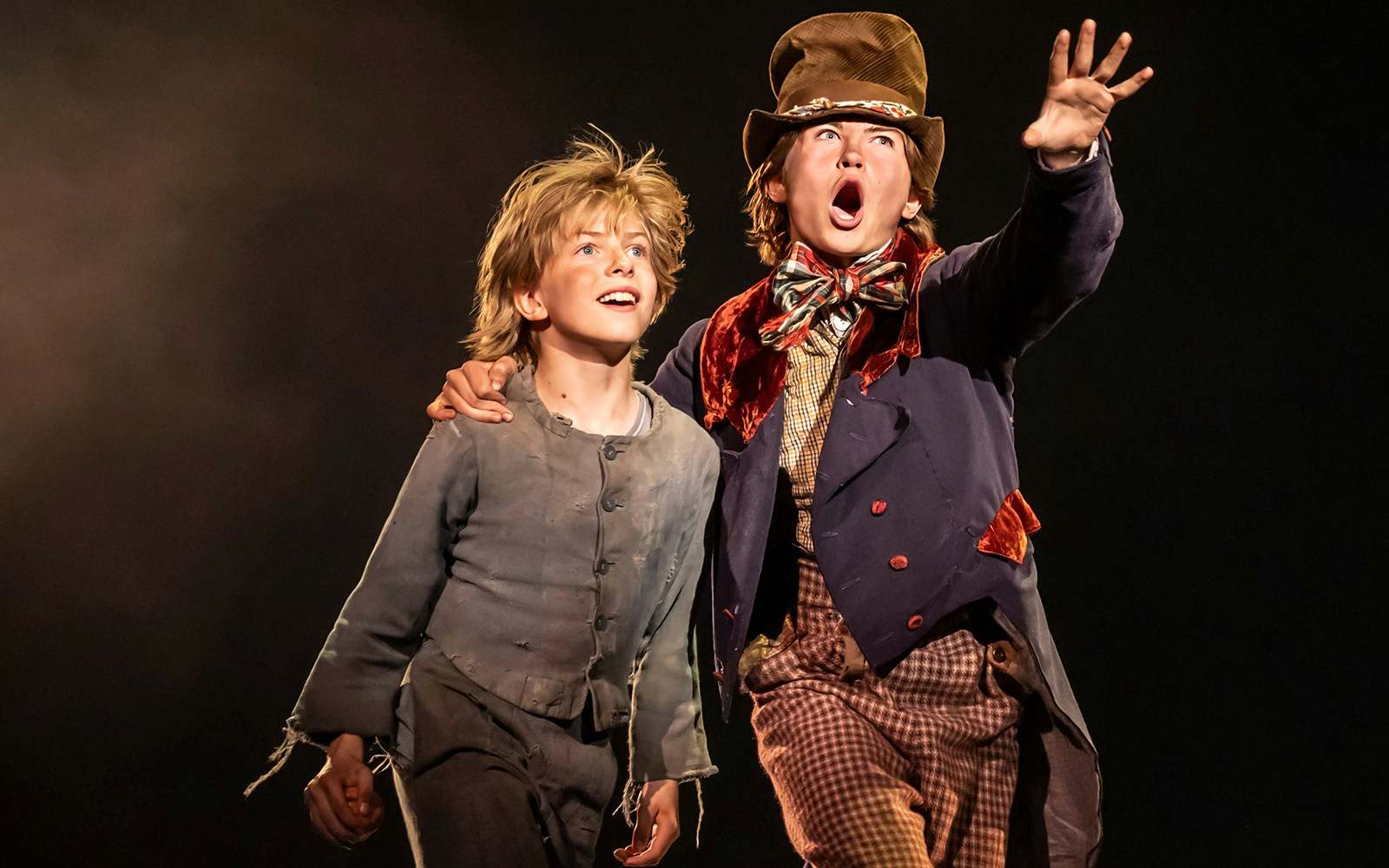 Two actors on stage performing a scene from the musical Oliver!