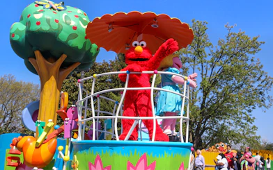 Sesame Street characters on a parade float at Sesame Place Philadelphia.