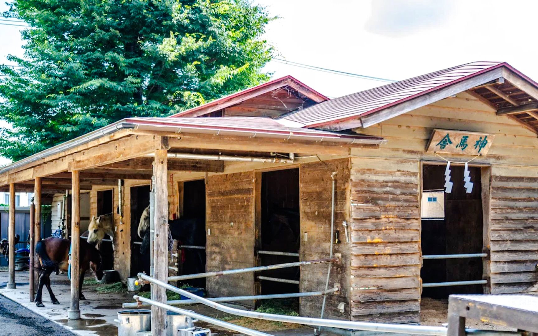 Wooden stable with horses at Shimomiya of Komuro Asama Shrine, Fujiyoshida.