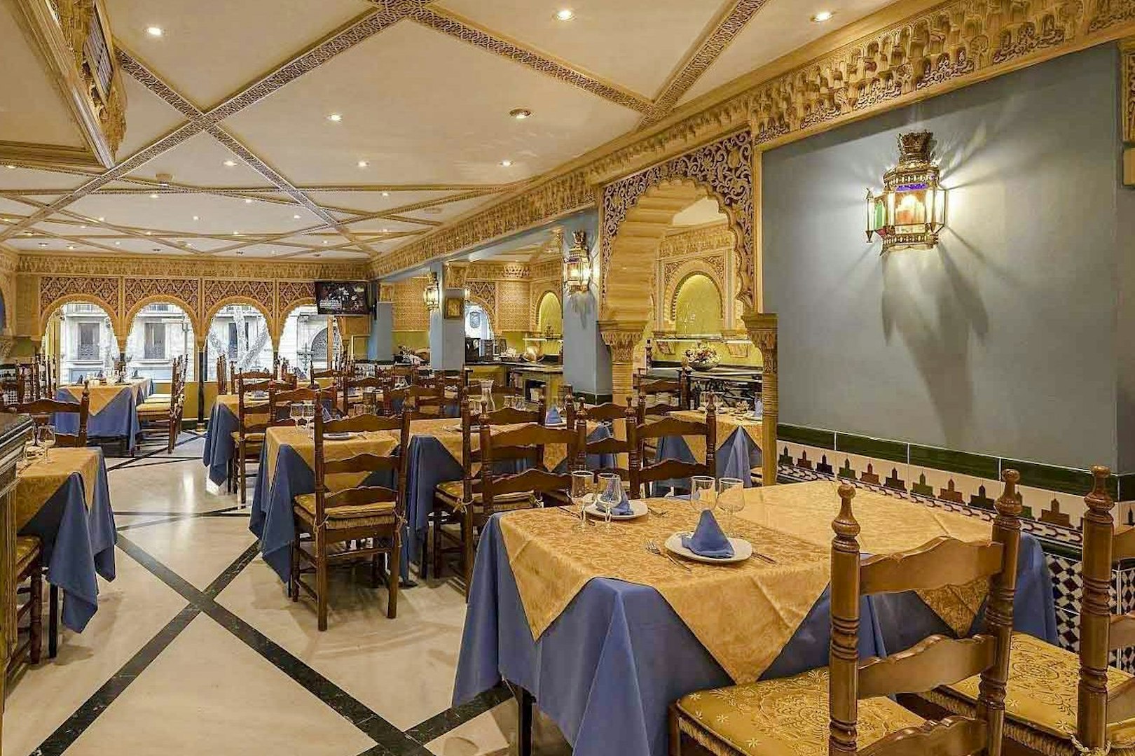 Interior of Tablao Cordobes with ornate decor and set dining tables.