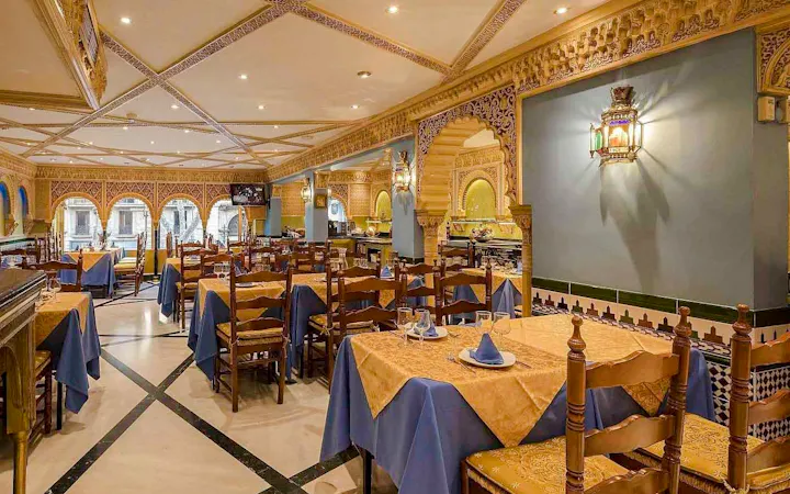 Interior of Tablao Cordobes with ornate decor and set dining tables.