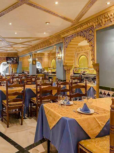 Interior of Tablao Cordobes with ornate decor and set dining tables.
