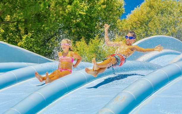 Children enjoying a water slide at Parco Cavour Water Park.