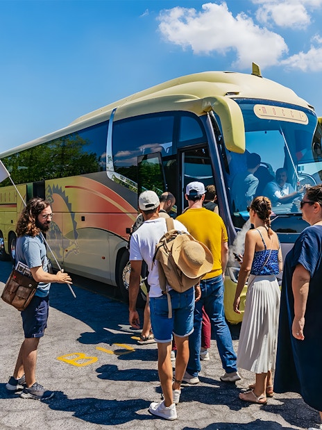 Tour group boarding bus for Roman Basilicas & Catacombs tour on Appian Way.