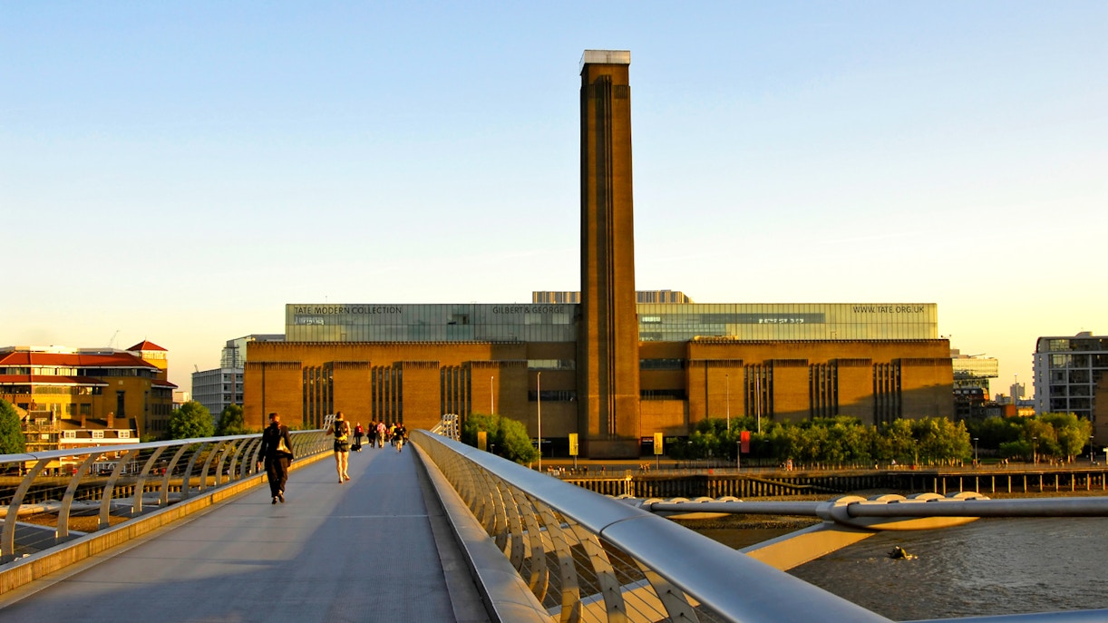 Millennium Bridge leading to Tate Modern in London at sunset.
