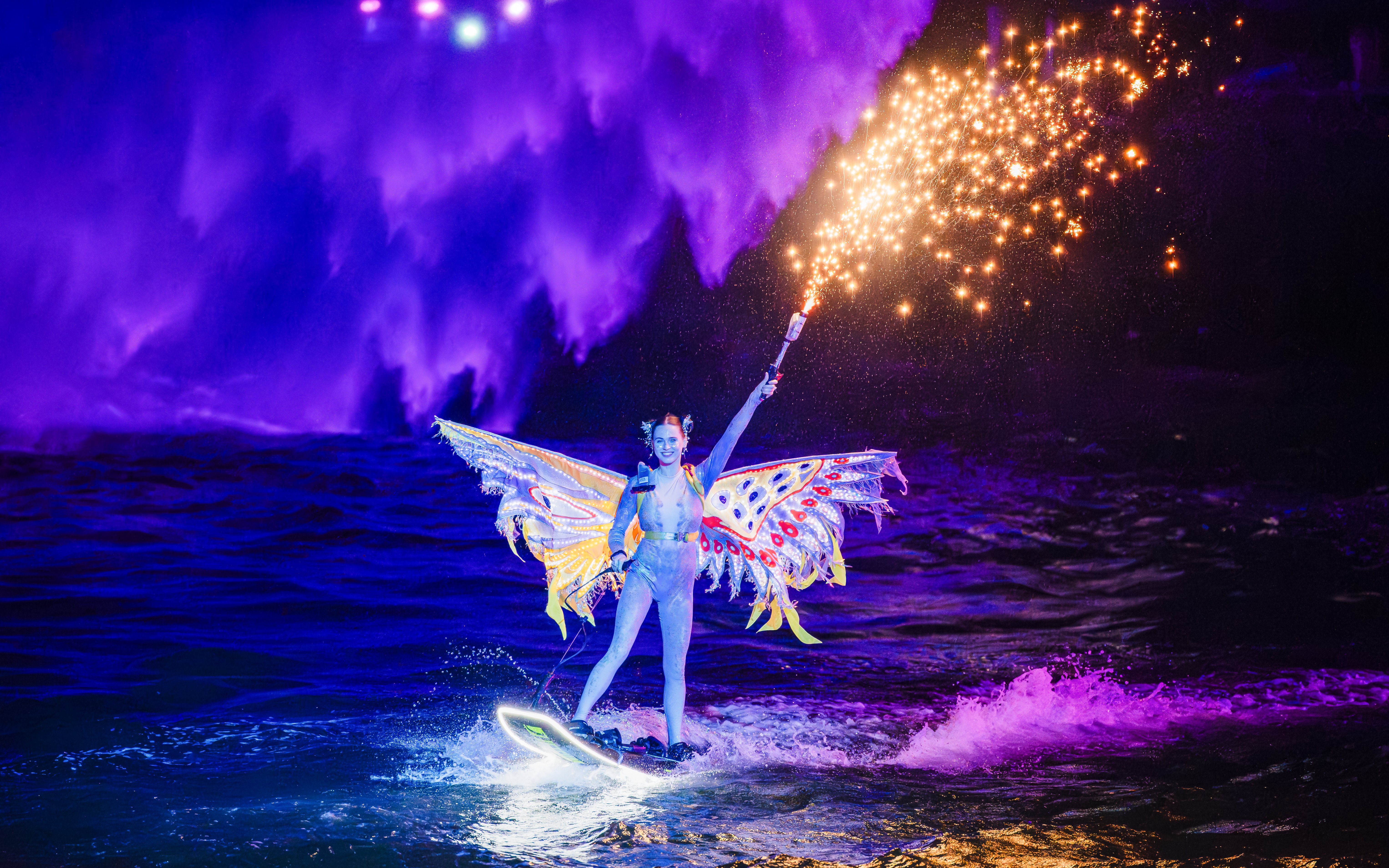 Lady performing jet ski stunts with fireworks at Symphony of the Sea show.