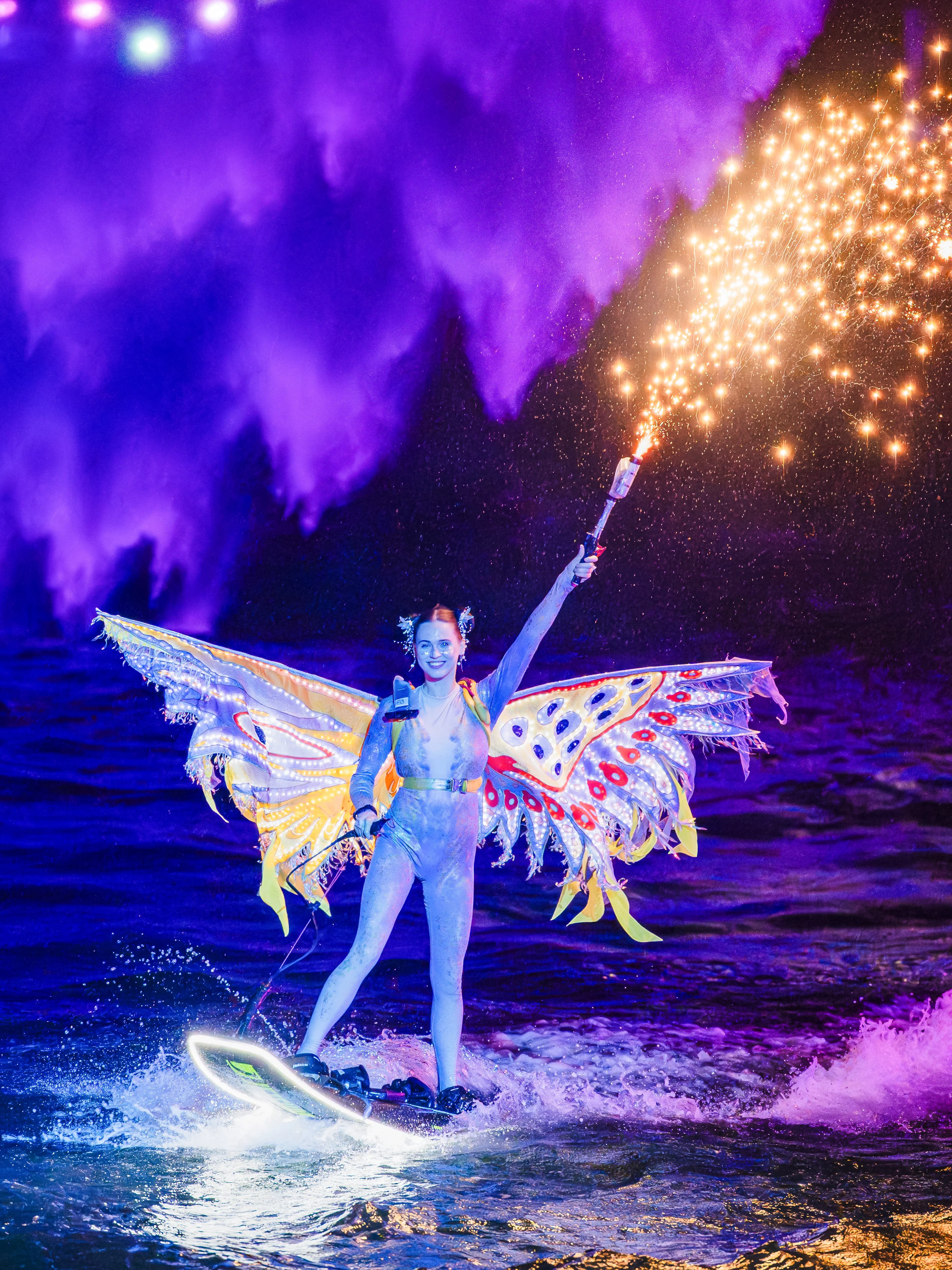 Lady performing jet ski stunts with fireworks at Symphony of the Sea show.