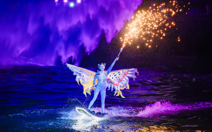 Lady performing jet ski stunts with fireworks at Symphony of the Sea show.
