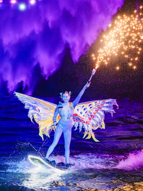 Lady performing jet ski stunts with fireworks at Symphony of the Sea show.