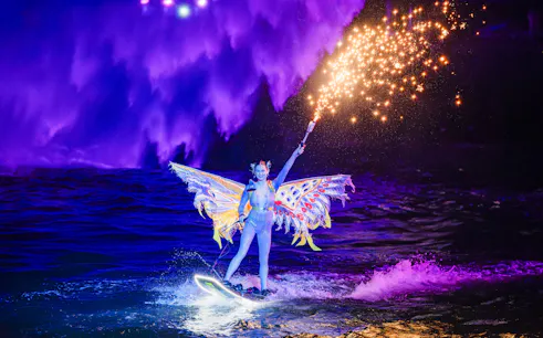 Lady performing jet ski stunts with fireworks at Symphony of the Sea show.