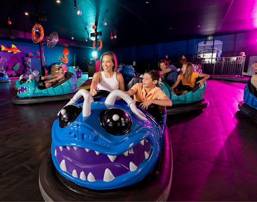 Bumper car ride at Dreamworld Gold Coast with colorful lights and excited riders.