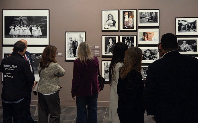 Tourists viewing black-and-white photographs at the Russian Museum exhibition.