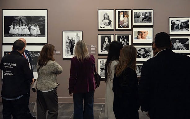 Tourists viewing black-and-white photographs at the Russian Museum exhibition.
