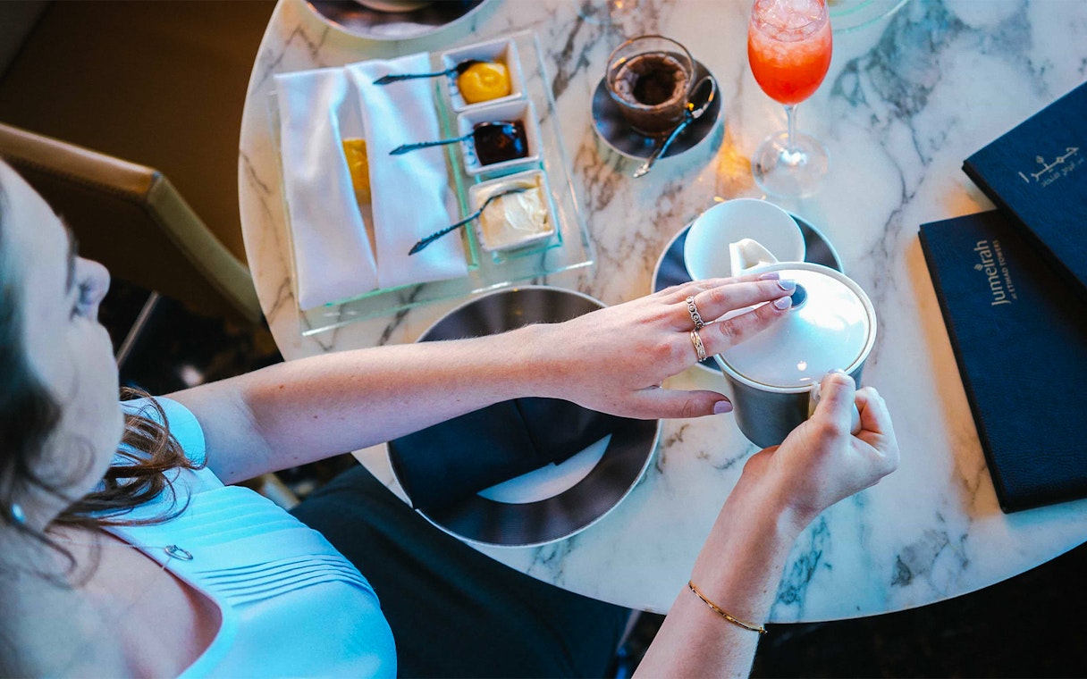 Dining experience at Observation Deck at 300, Etihad Tower, Abu Dhabi with tea and desserts.