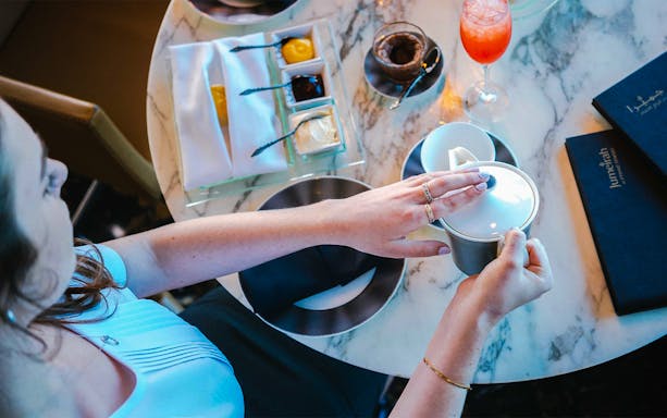 Dining experience at Observation Deck at 300, Etihad Tower, Abu Dhabi with tea and desserts.