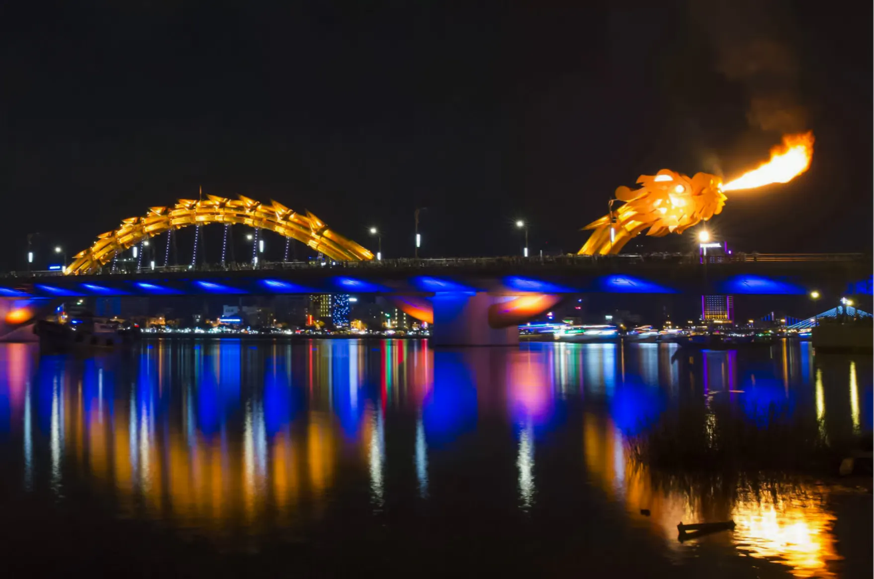 Dragon Bridge lit up at night with fire-breathing display, Da Nang.