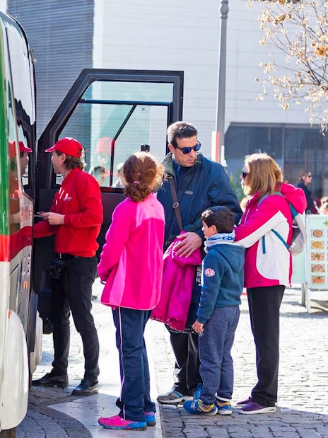 Tourists boarding a tour bus in Granada.