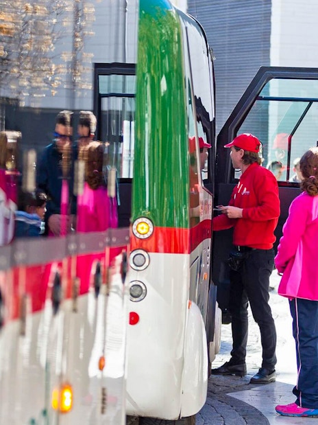 Tourists boarding a tour bus in Granada.