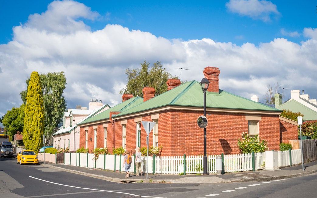 Historic red brick building on a street corner in Hobart, Tasmania, seen on the Red Decker bus tour.