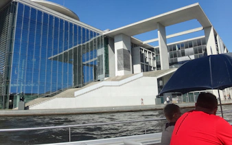 Berlin sightseeing cruise view of modern riverside building near Hackescher Markt.