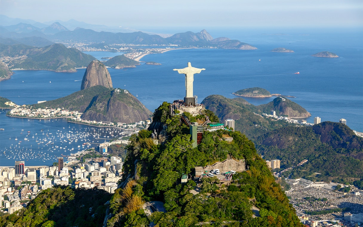 Christ the Redeemer overlooking Rio de Janeiro with Sugarloaf Mountain in the background.
