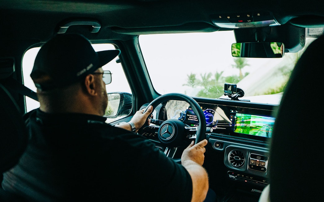 Tourist driving Mercedes-Benz at Mercedes-Benz Experience Dubai.