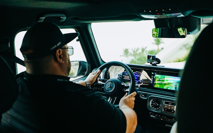 Tourist driving Mercedes-Benz at Mercedes-Benz Experience Dubai.